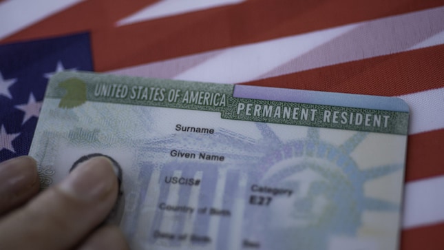 Remaining outside the US for more than a year without a valid re-entry permit may lead to being classified as having abandoned permanent residency.