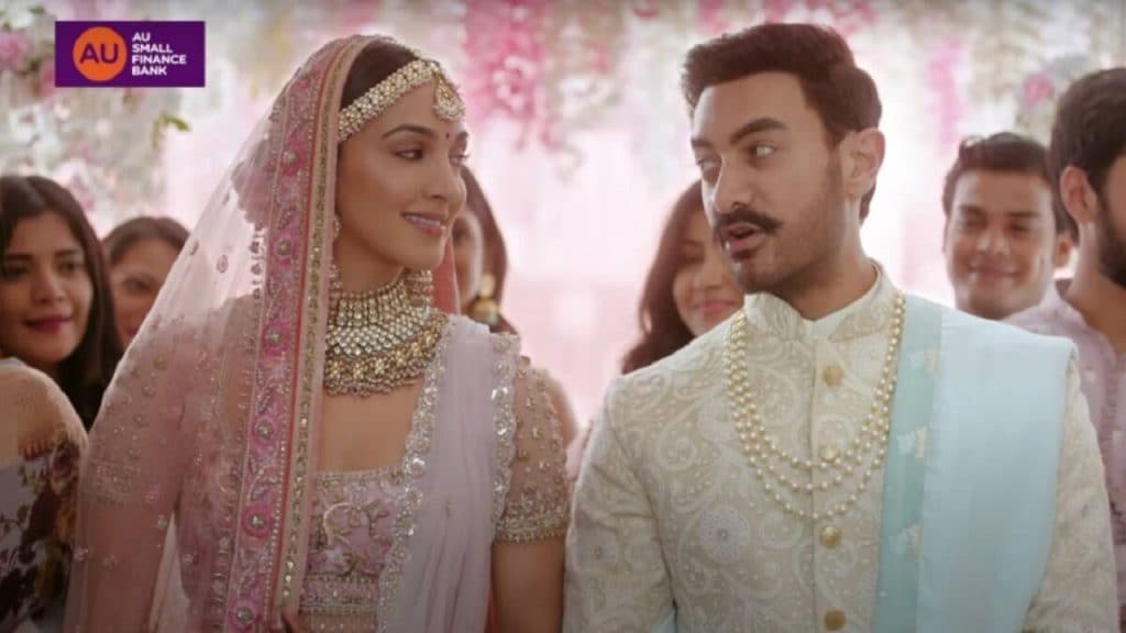 A still from small finance bank AU Bank's controversial ad featuring Aamir Khan and Kiara Advani.